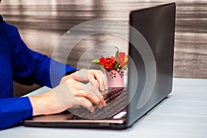 Young man working with laptop, man`s hands on notebook computer