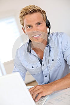 Young man working in office with headset