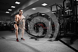 Young man working out with battle ropes