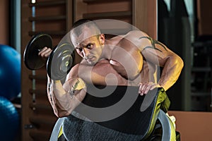 Young Man Working Out In A Health Club