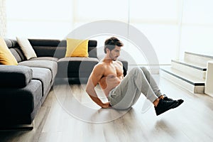 Young Man Working Out At Home For Healthy Lifestyle And Fitness
