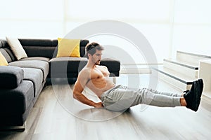 Young Man Working Out At Home For Healthy Lifestyle And Fitness