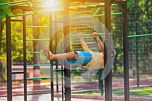 Young man working out at an outdoor parallel bar