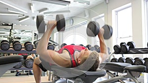 Young Man Working Out With Weights In Gym