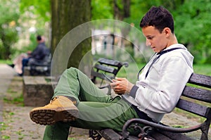 Young man working on pad device in the park