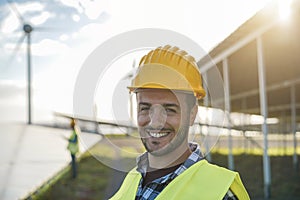 Young man working at renewable energy farm - Eco and enviroment concept - Focus on face