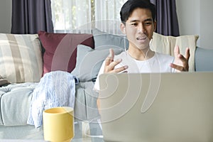 Young man working and studying online at home.