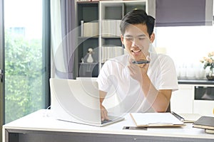 Young man working and studying online at home.