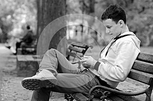 Young man working on tablet in the park