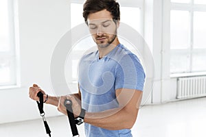 Young man during workout with a resistance bands in the gym