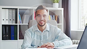 Young Man Works while Sitting in front of a Computer at Home. The Workplace of a Professional Worker, Freelancer or