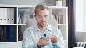 Young Man Works while Sitting in front of a Computer at Home. The Workplace of a Professional Worker, Freelancer or