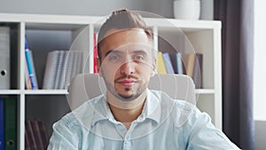 Young Man Works while Sitting in front of a Computer at Home. The Workplace of a Professional Worker, Freelancer or