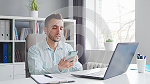 Young Man Works while Sitting in front of a Computer at Home. The Workplace of a Professional Worker, Freelancer or