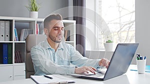 Young Man Works while Sitting in front of a Computer at Home. The Workplace of a Professional Worker, Freelancer or