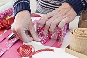Young man wrapping a gift