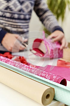 Young man wrapping a gift