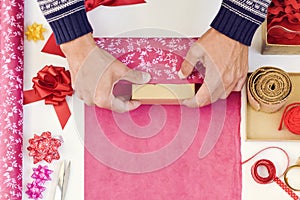 Young man wrapping a gift