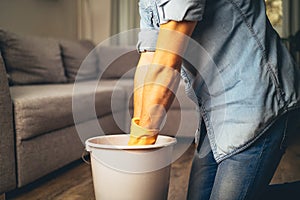 young man wringing out mopping cloth to clean the floor