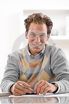 Young man writing at desk