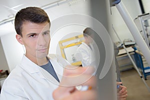Young man writing on easel