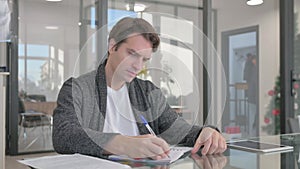 Young Man Writing a Letter in Office