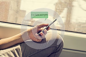 Young man writing a message to apologize