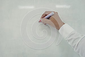 Young man is writing on whiteboard.