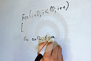 Young man writing on a whiteboard