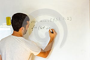 Young man writing on a whiteboard