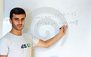 Young man writing on a whiteboard