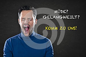 Young man yawning tired and bored with text `MÃÂ¼de? Gelangweilt? Kommt zu uns!`.Trans:  `Tired? Bored? Come to us!