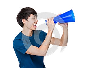 Young man yell with loudspeaker