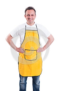 Young man with yellow apron posing confident