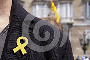 Man with a yellow ribbon in Barcelona, Spain photo