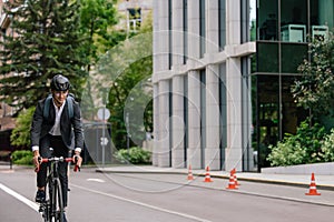 Young manager comuting to the office by electic scooter