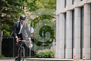 Young manager comuting to the office by electic scooter