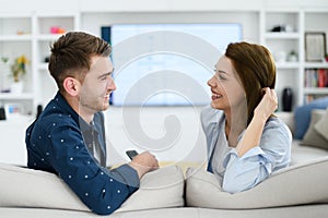 a young married couple enjoys sitting in the large living room