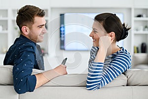 a young married couple enjoys sitting in the large living room