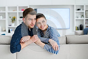 a young married couple enjoys sitting in the large living room