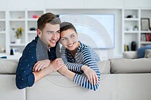 a young married couple enjoys sitting in the large living room