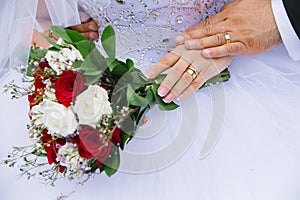 Young married couple holding hands closeup