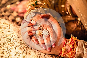 Young married couple holding hands, indian ceremony wedding day