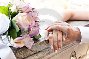 Young married couple holding hands on wedding day, love and happiness