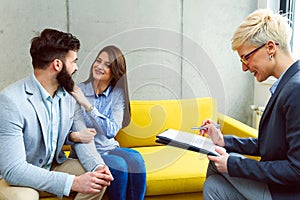 Young married couple with real estate agent