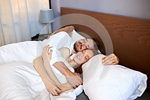 Young married couple sleep together, lie on bed