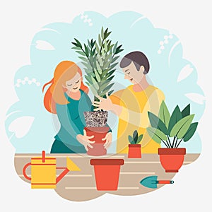 A young married couple transplants a plant