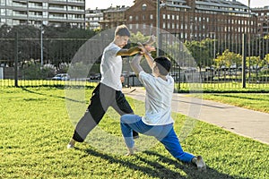 Young martial artists practicing a grappling hold outdoors