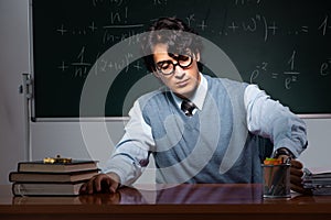 The young math teacher in front of chalkboard