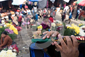 A young Maya is playing her flute at the Chichicastenango Guatemala market.